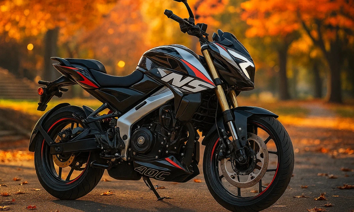 2025 Bajaj Pulsar NS400Z in black and red parked on an autumn road with leaves and blurred trees in the background