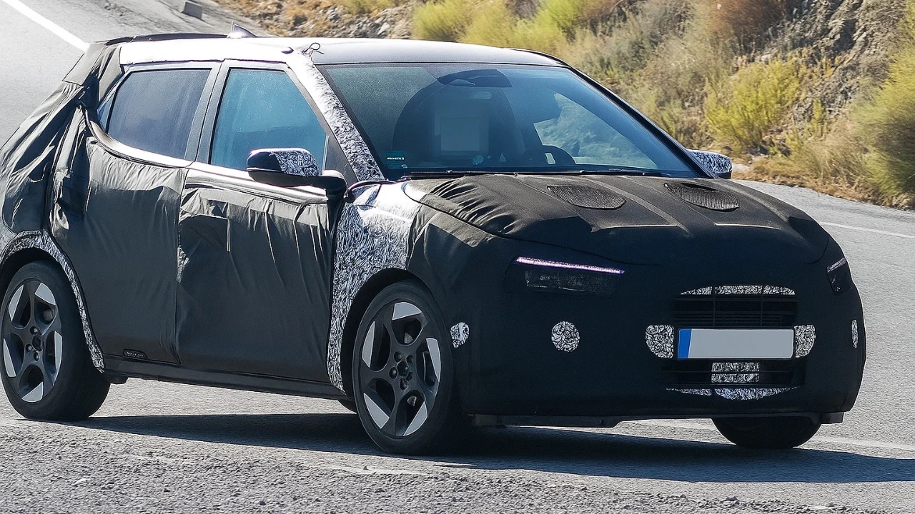 New-Gen Hyundai i20 test mule with heavy camouflage on the front and rear, showing the new grille and futuristic LED DRLs while being tested on a road.